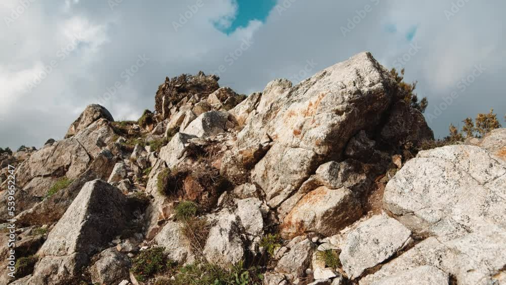 Top of a dry mountain with stones and gray soil Top of a dry mountain with stones and gray soil
