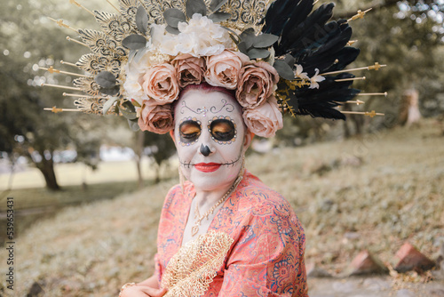 Portrait of Mexican woman made up as a catrina.