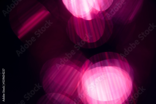 Blur pink rainbow crystal light leaks on black background. Defocused abstract multicolored retro film lens flare bokeh analog photo overlay or screen filter effect. Glow Vintage prism colors