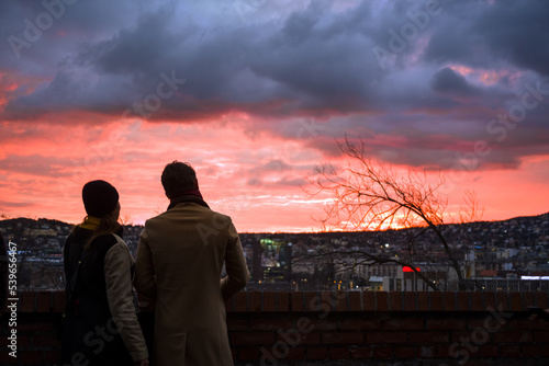 Silhouette of a couple against stormy sunset