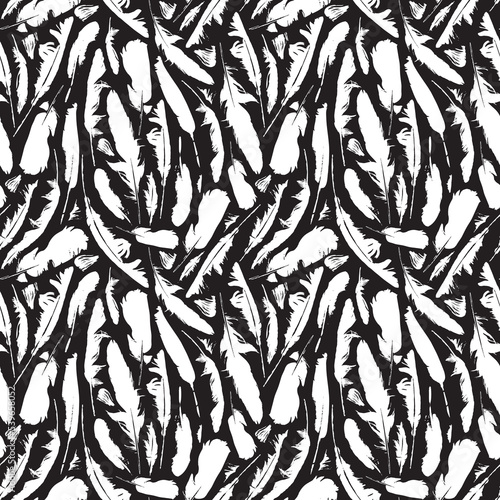 Abstract seamless pattern with scattered bird feathers. White feathers on a black backdrop. Monochrome vector background with disheveled plumelets. Good for wallpaper, wrapping paper, fabric design