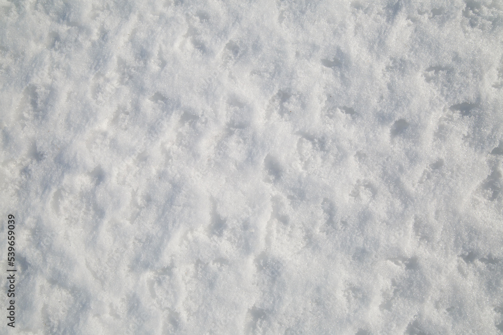 Snowy surface with footprints outside.
