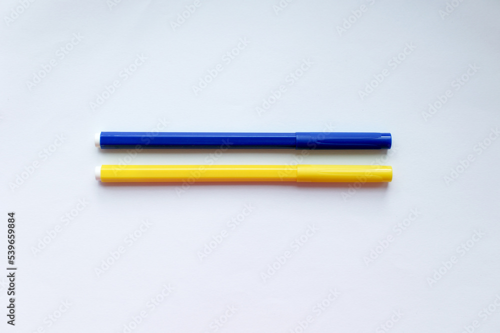 Two blue-yellow pencils on a white background as the flag of Ukraine Two blue-yellow pencils on a white background as the flag of Ukraine