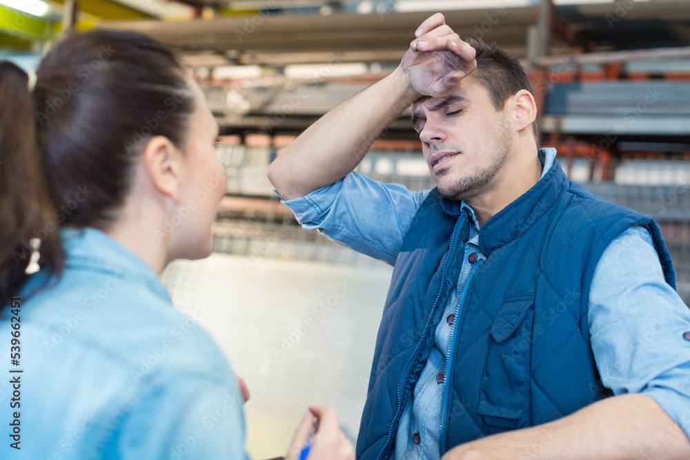 Obraz premium portrait of two tired workers at warehouse