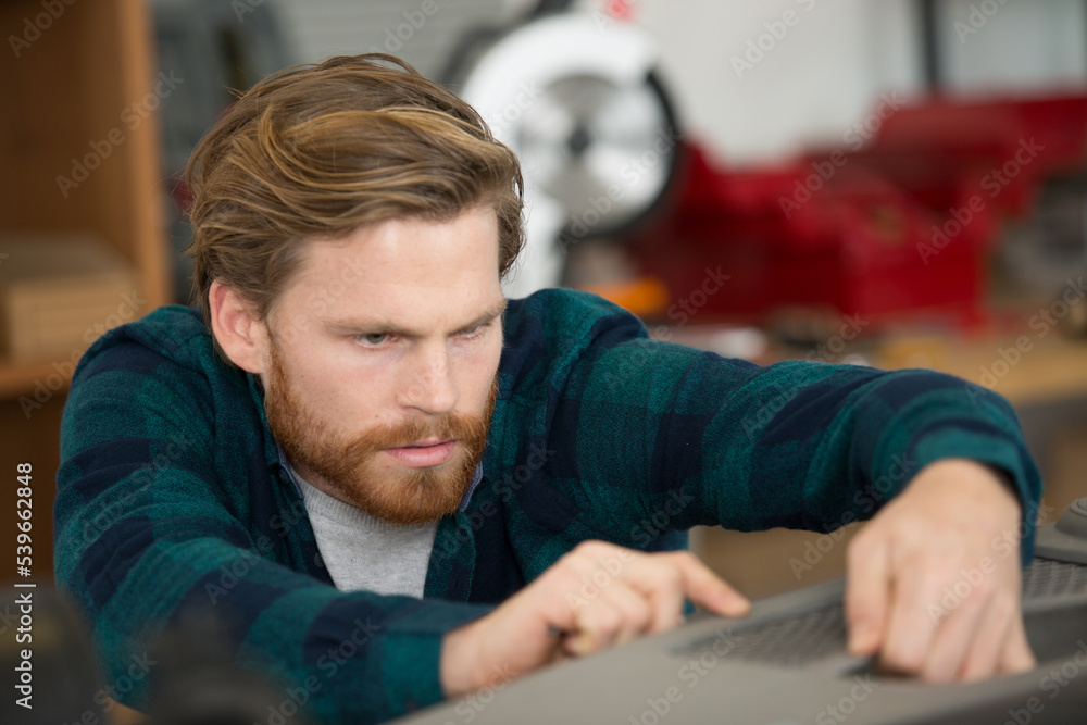 man is oldering a machine parts man is oldering a machine parts