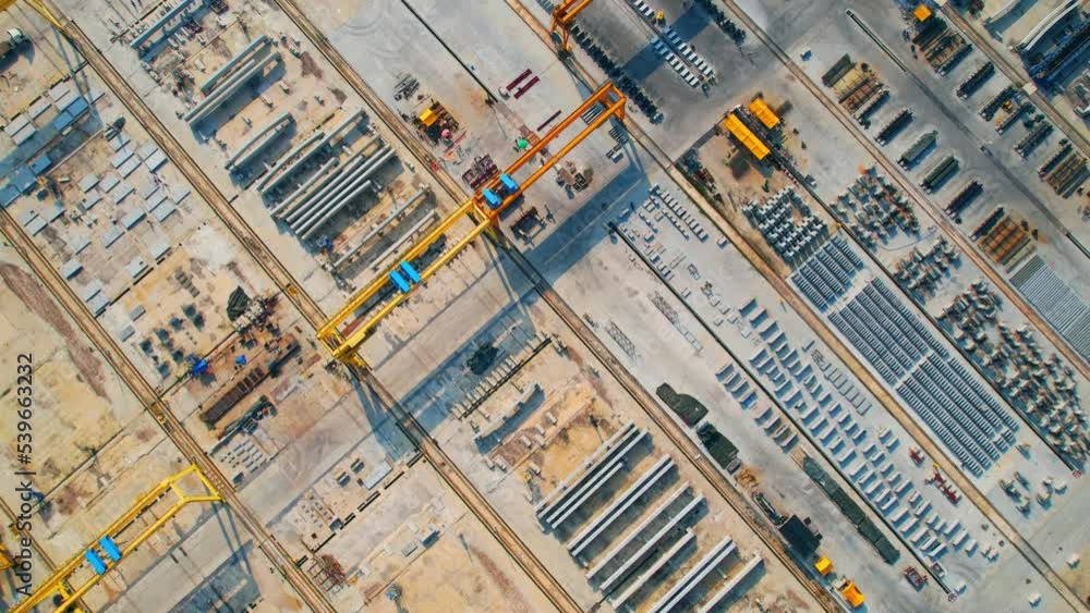 Aerial view over the Foundry of concrete bridge parts and concrete road parts. concrete industry. infrastructure industry. Drone. 4K
Aerial view over the Foundry of concrete bridge parts and concrete road parts. concrete industry. infrastructure industry. Drone. 4K