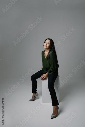 Vertical portrait of beautiful middle-aged woman posing on white background. © face_reader_img