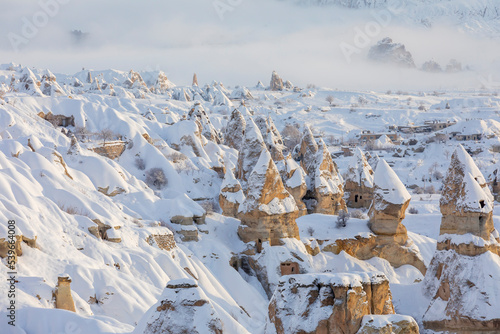 Pigeon Valley and Cave town in Goreme during winter time. Cappadocia, Turkey.  photo