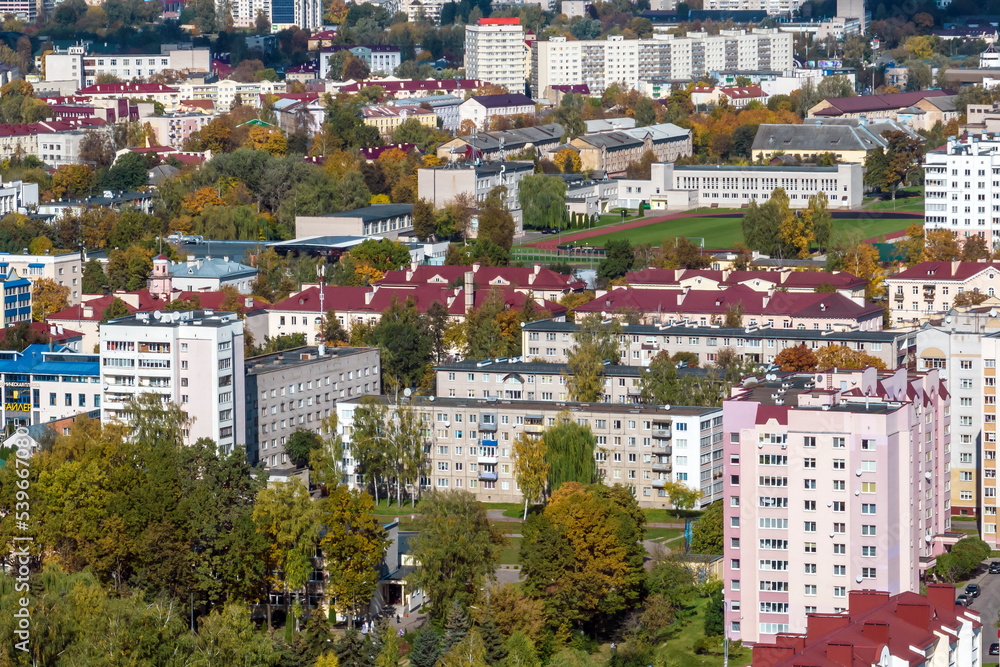 aerial panoramic view from height of a multi-storey residential complex and urban development in autumn day
