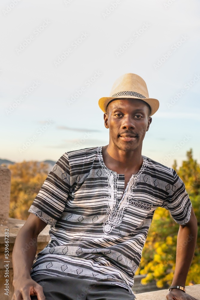 Man of black origin with hat at sunset in Montjuic, Barcelona (Spain), travel concept. Man of black origin with hat at sunset in Montjuic, Barcelona (Spain), travel concept.