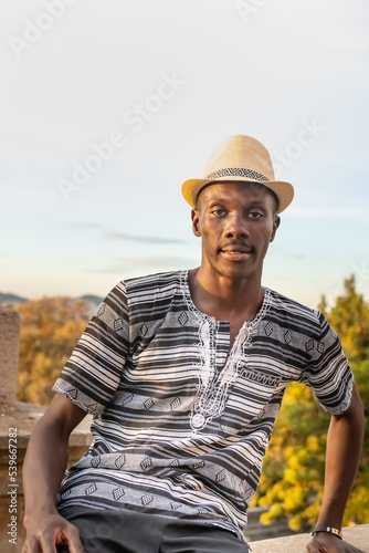 Man of black origin with hat at sunset in Montjuic, Barcelona (Spain), travel concept.