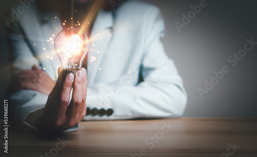 Businesswoman holding a light bulb, Creative new idea. Innovation, brainstorming, solution and inspiration concepts. imagination, creative thinking problem solving..