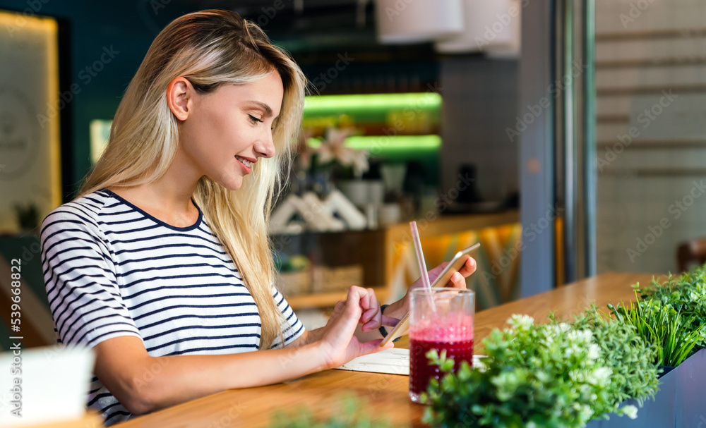 Portrait of happy woman smiling and using mobile phone. People technology social network concept Portrait of happy woman smiling and using mobile phone. People technology social network concept