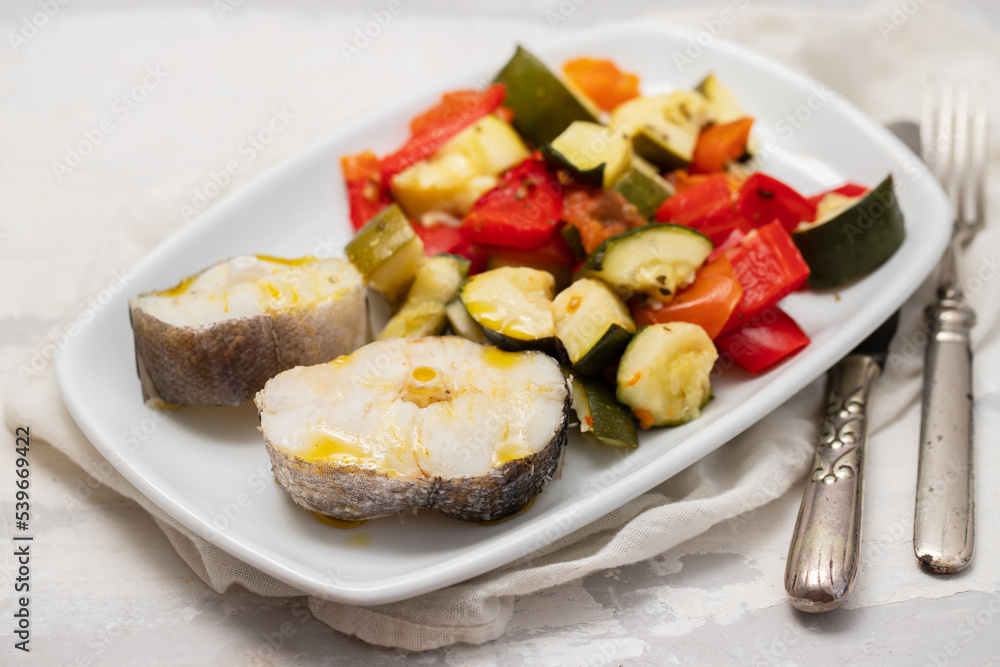 baked vegetables with boiled fish on white plate baked vegetables with boiled fish on white plate