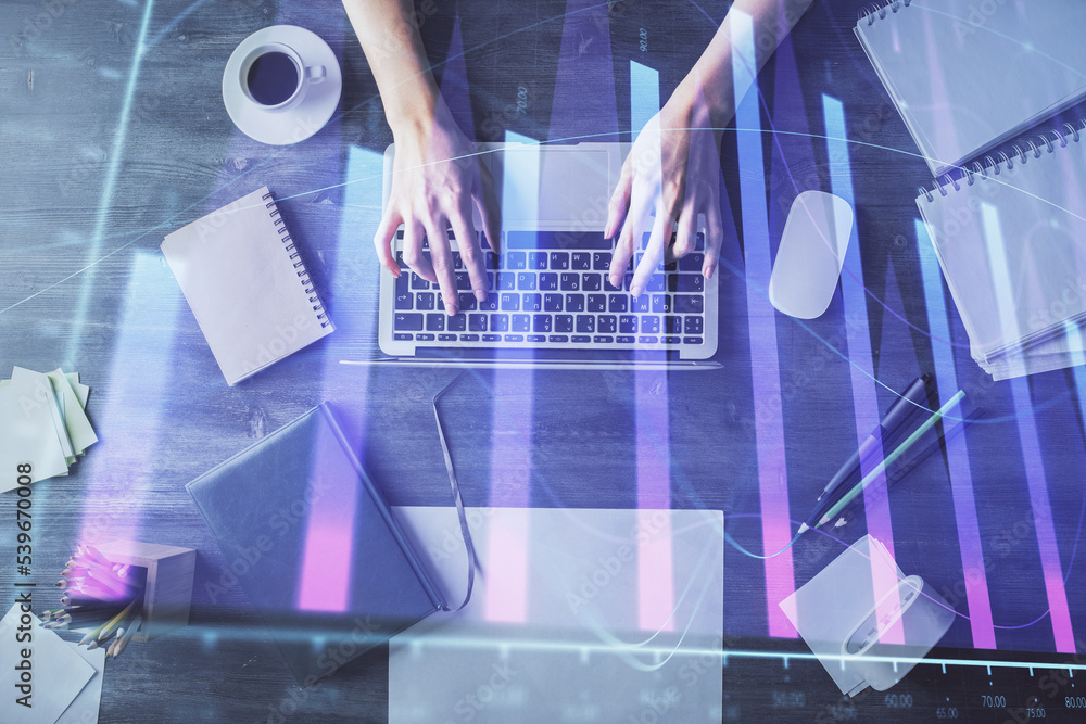 Multi exposure of woman hands working on computer and forex chart hologram drawing. Top View. Financial analysis concept. Multi exposure of woman hands working on computer and forex chart hologram drawing. Top View. Financial analysis concept.