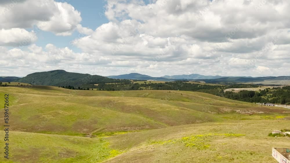 Green Zlatibor mountain hill landscape with beautiful clouds in background, high angle view from cable car gondola Green Zlatibor mountain hill landscape with beautiful clouds in background, high angle view from cable car gondola
