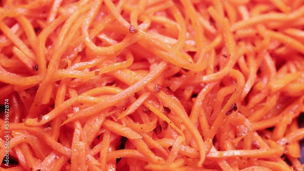 Bulk heap of Korean salad of chopped carrots, garlic, vegetable oil Bulk heap of Korean salad of chopped carrots, garlic, vegetable oil