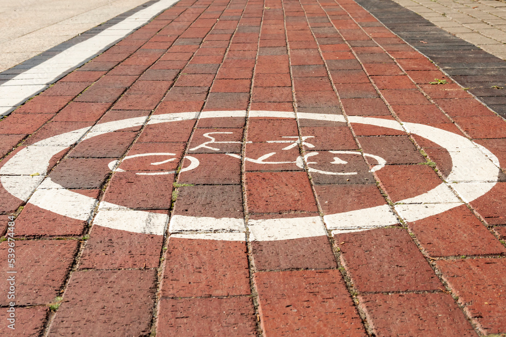 Bike path. Traffic sign for bicycles on paving stones.