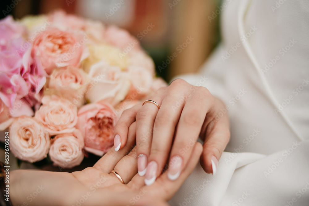 Well-groomed hands with beautiful nails on a background of flowers Well-groomed hands with beautiful nails on a background of flowers