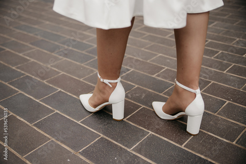 Women's white shoes on feet