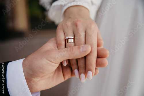 Hand in hand. Romantic background with rings. Hugs of lovers