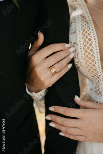 Hand in hand. Romantic background with rings. Hugs of lovers