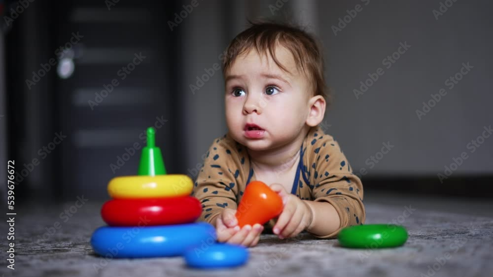 Small cute boy playing with colorful toys. Educational baby activity with toy. Small cute boy playing with colorful toys. Educational baby activity with toy.