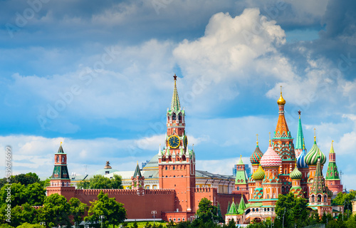 Spasskaya Tower of Moscow Kremlin and Cathedral of Vasily the Blessed (Saint Basil's Cathedral) on Red Square in summer day. Black clouds before the rain. Panorama. Moscow. Russia