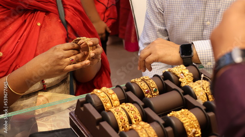 Bangalore, India 4th May 2022: Indian customer in a jewellery exhibition buying gold on the occasion of Dhanteras and Vijayalaxmi. Traditional ornaments with marvelous stones and intricate designs.