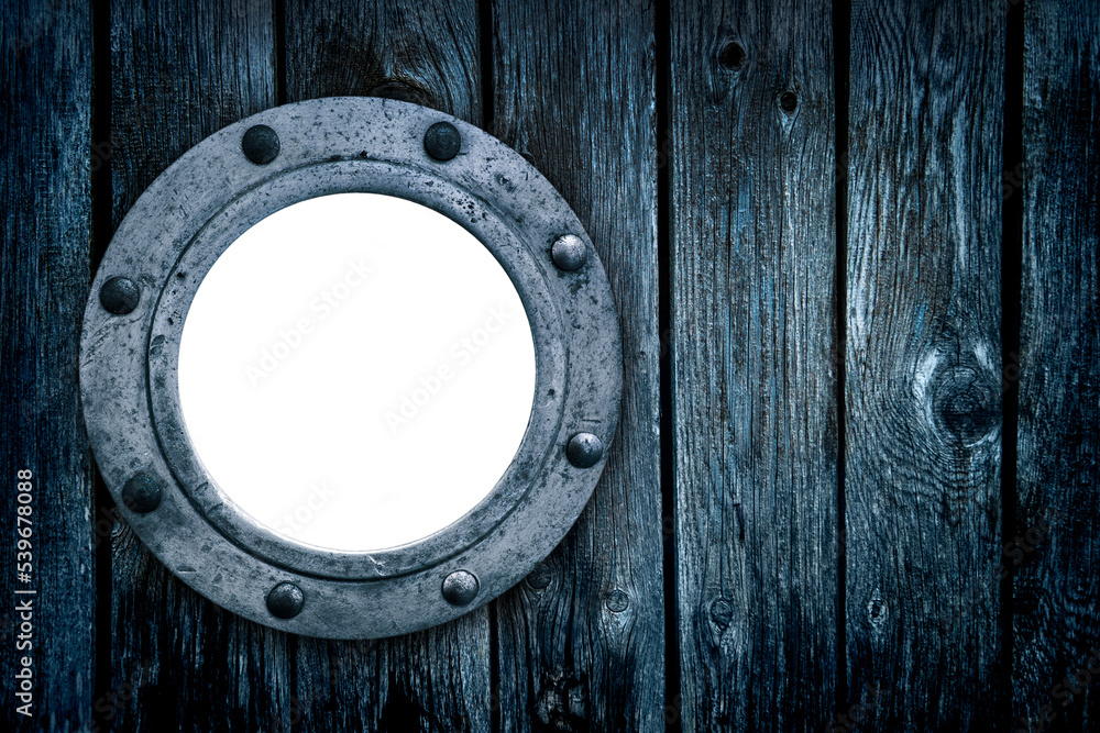 Close-up of an old rusty closed empty porthole window. Old blue rich wood grain texture background with knots. Close-up of an old rusty closed empty porthole window. Old blue rich wood grain texture background with knots.