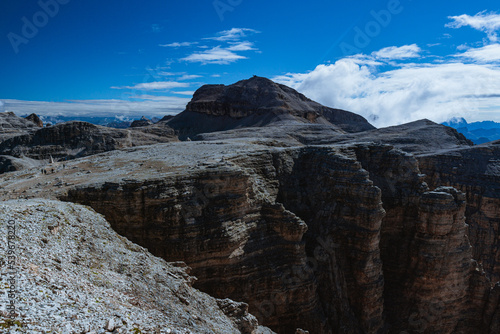 The landscape of the Dolomites seen from the Sella group: one of the most famous and spectacular mountain massifs in the Alps, near the town of Canazei, Italy - July 2022.