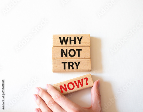 Why not try symbol. Concept words Why not try on wooden blocks. Beautiful white background. Businessman hand. Business and Why not try concept. Copy space.