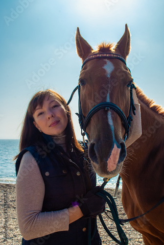 Selective focus. Girl and horse. Horse riding by the sea. © Юлия Тарабанова