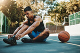 Basketball court, man and shoes prepare for training at recreation and athlete facility. Sports, exercise and fitness male with lace tie getting ready for ball game workout and cardio.