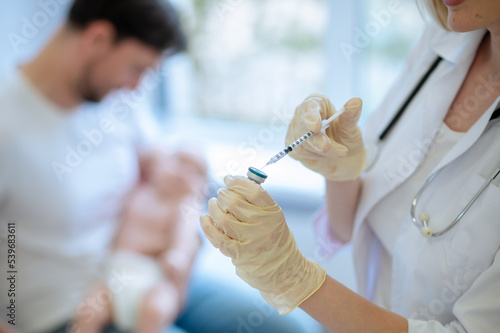 Doctor preparing to administer an injection to a patient