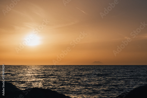 Stromboli volcano smoke and sunset over Tyrrhenian  Mediterranean Sea.  View from Coast of Gods  Calabria  southern Italy.