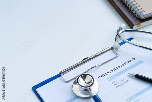 Stethoscope with medical records invoice. on white background.