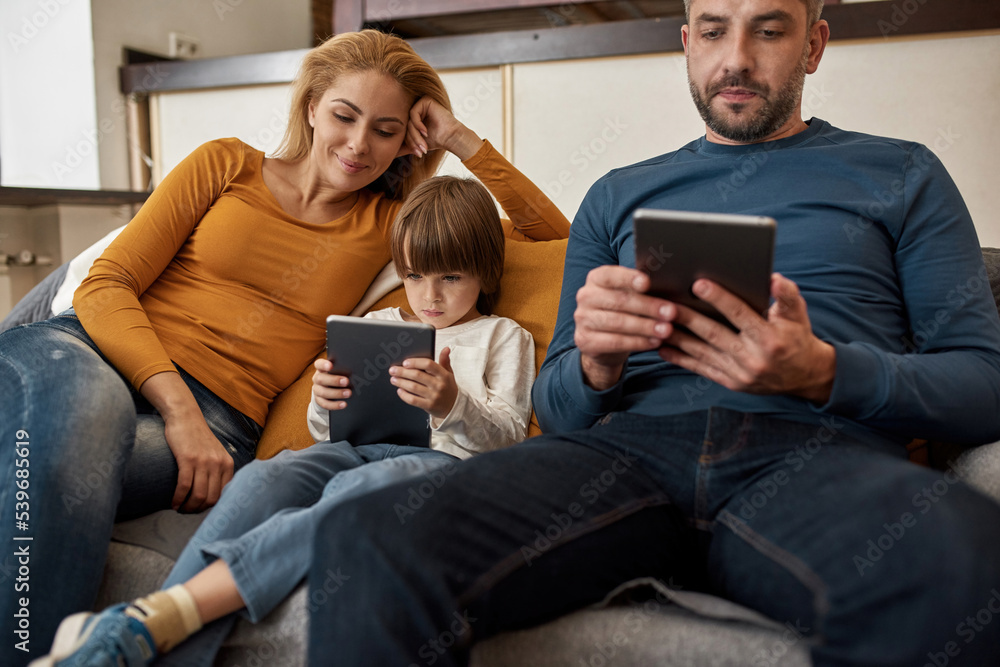 European family watching digital tablets at home European family watching digital tablets at home
