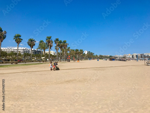 Salou, Spain, June 2019 - A group of people riding on top of a sandy beach