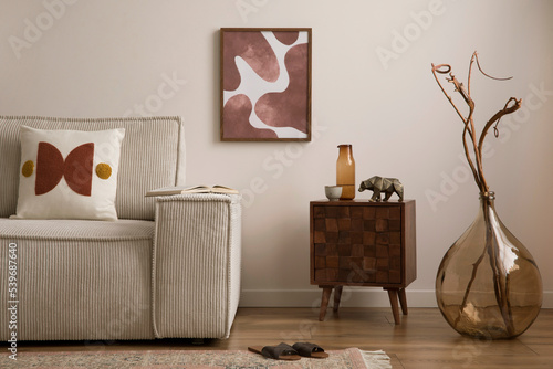 Schilderij op canvas Creative composition of modern living room interior with mock up poster frame, corduroy sofa, coffee table, vase with dried flowers, carpet, pillow, slippers and personal accessories