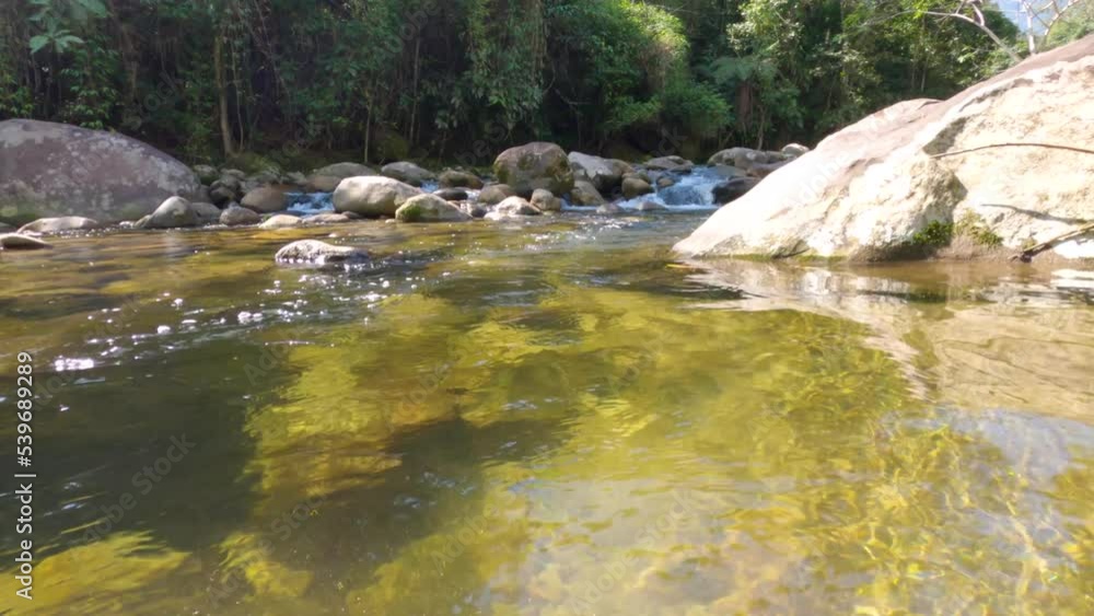 Following against the current of crystalline waters of a stream course in Angra dos Reis. waterfall course Following against the current of crystalline waters of a stream course in Angra dos Reis. waterfall course