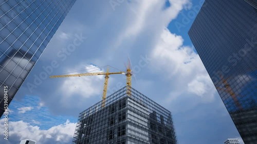 High skyscraper being built by construction cranes in a one day timelapse. 4K HD