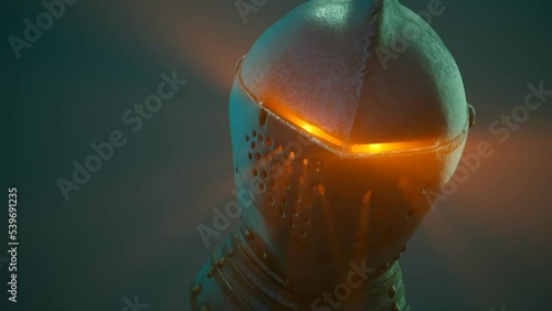 A medieval knight's soul shines bright through helmet holes illuminating a fog. photo