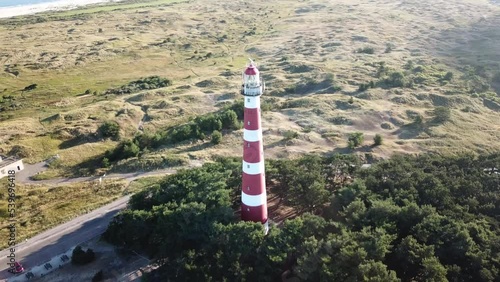 The lighthouse of Ameland in the summer morning sun from a drone perspective photo
