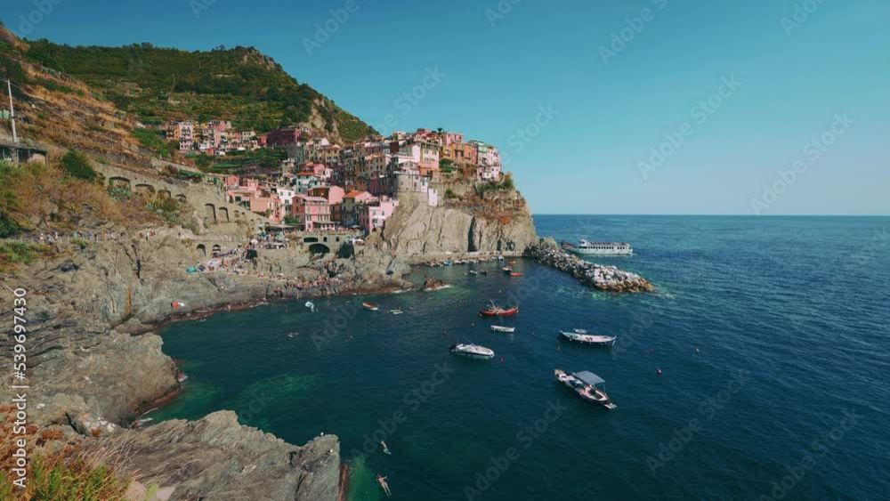 Cinque Terre with the villages Monterosso, Vernazza, Corniglia, Manarola and Riomaggiore at the Mediterranean seaside coast of Italy with fishing boat and tourists swimming. Cinemagraph seamless video Cinque Terre with the villages Monterosso, Vernazza, Corniglia, Manarola and Riomaggiore at the Mediterranean seaside coast of Italy with fishing boat and tourists swimming. Cinemagraph seamless video
