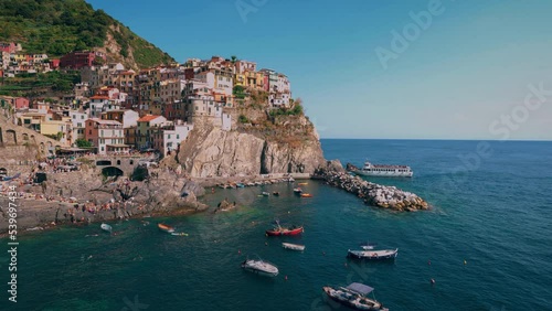 Cinque Terre with the villages Monterosso, Vernazza, Corniglia, Manarola and Riomaggiore at the Mediterranean seaside coast of Italy with fishing boat and tourists swimming. Cinemagraph seamless video photo