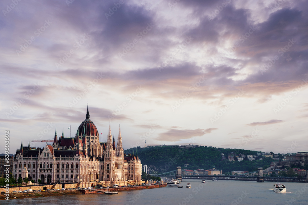 Fototapeta premium The Hungarian Parliament Building on the bank of the Danube in Budapest at sunset time.