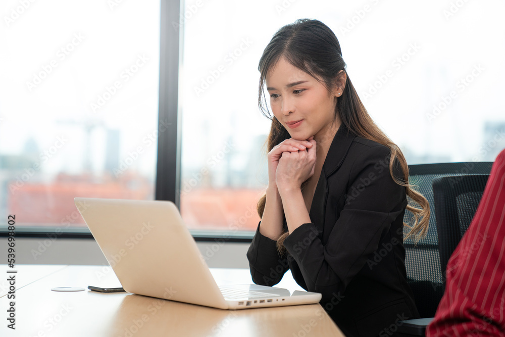 Successful asian businesswoman working and looking camera at her office desk, Concept of business risk analysis and assessment Successful asian businesswoman working and looking camera at her office desk, Concept of business risk analysis and assessment