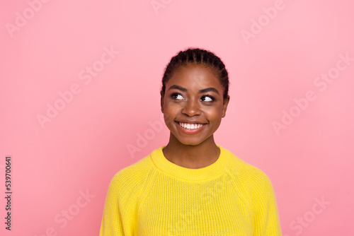Portrait of cheerful minded lady beaming smile look interested empty space isolated on pink color background © deagreez