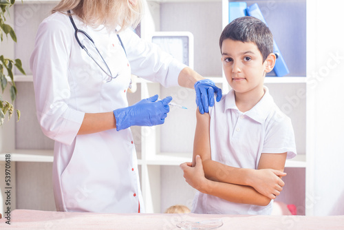 vaccination of children  a little boy at a doctor s appointment  an injection in the arm